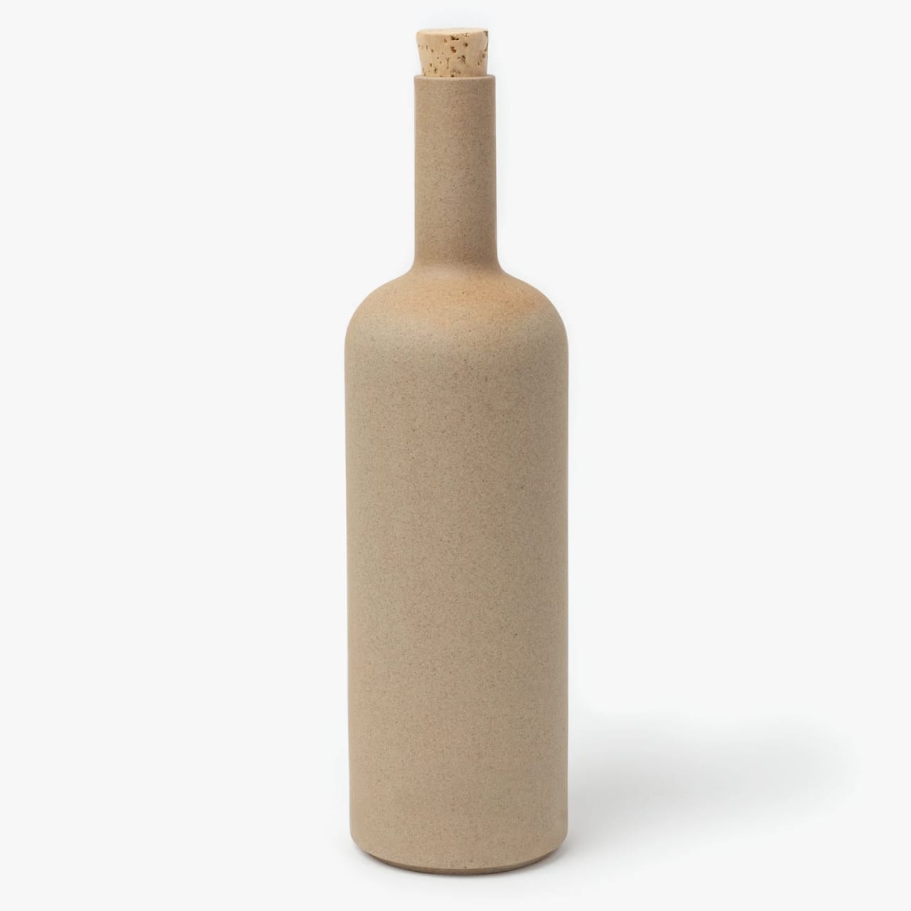 Tall slender porcelain bottle with natural clay textured body and cork stopper.