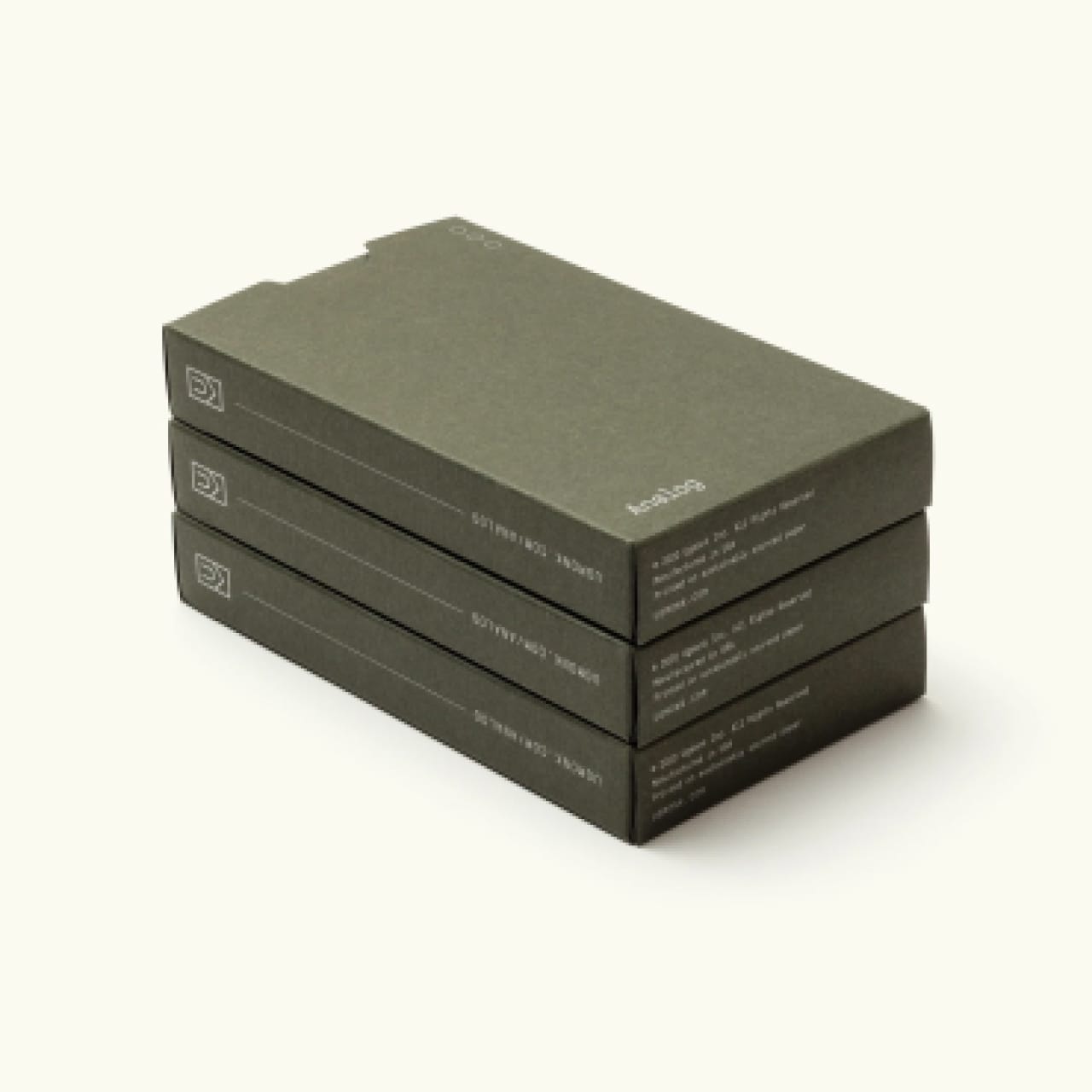 Stack of 3 small drab green cardboard paper card refill boxes with white text.